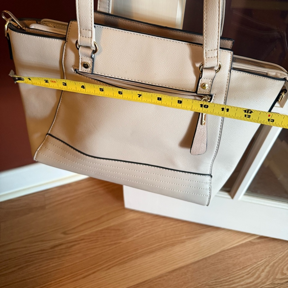 Next to new cream coloured bag with black piping and gold hardware
